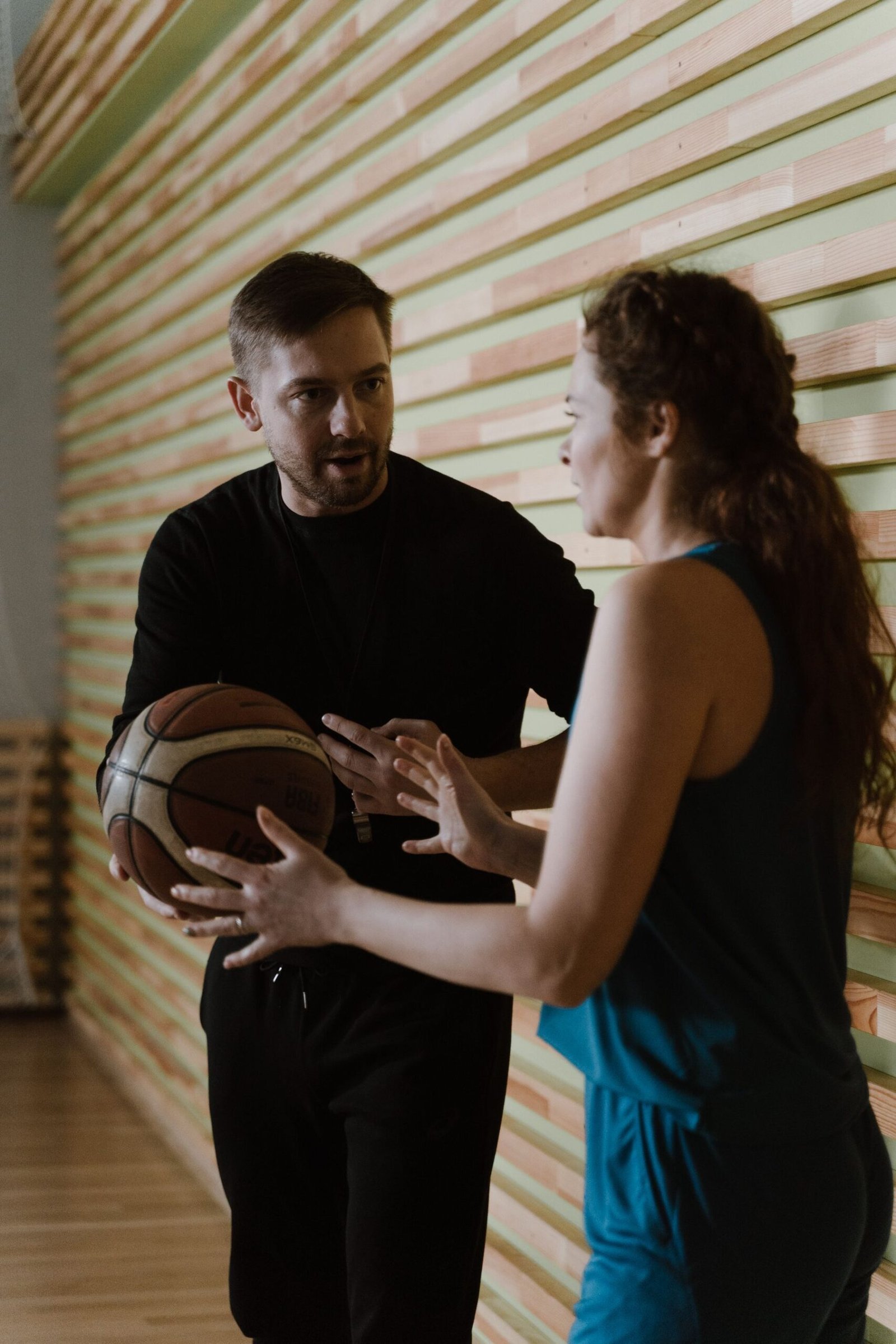 A coach talking one to one with a player during a training session