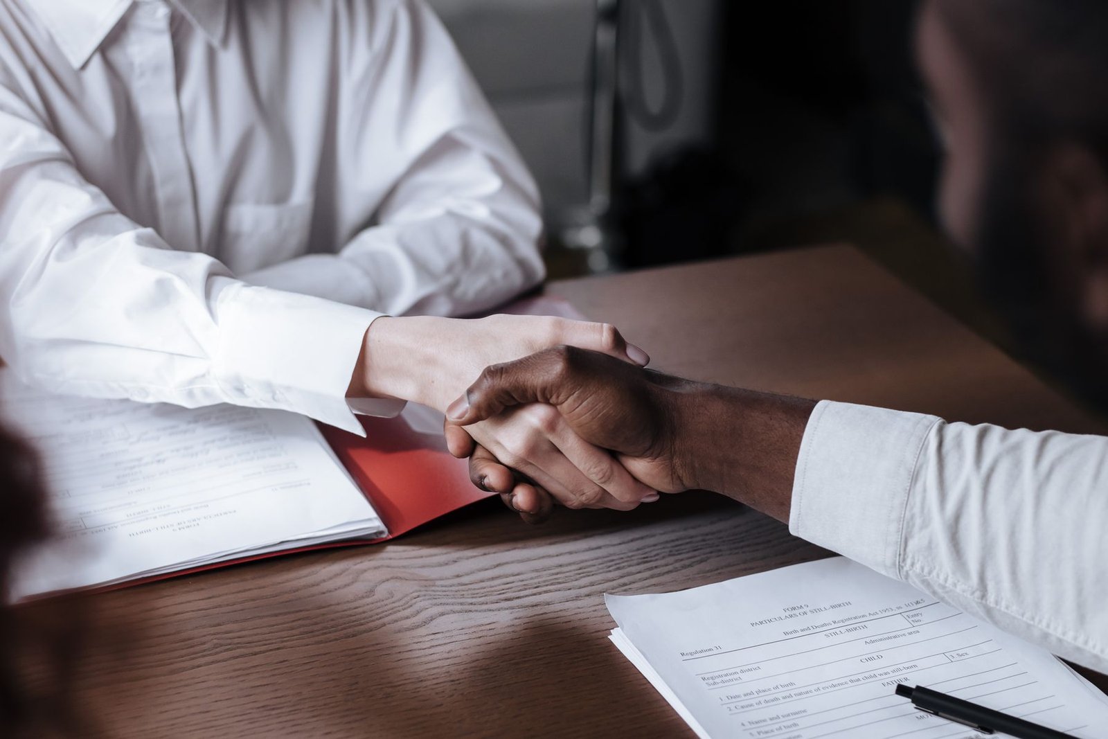 Handshake over a contract on a table